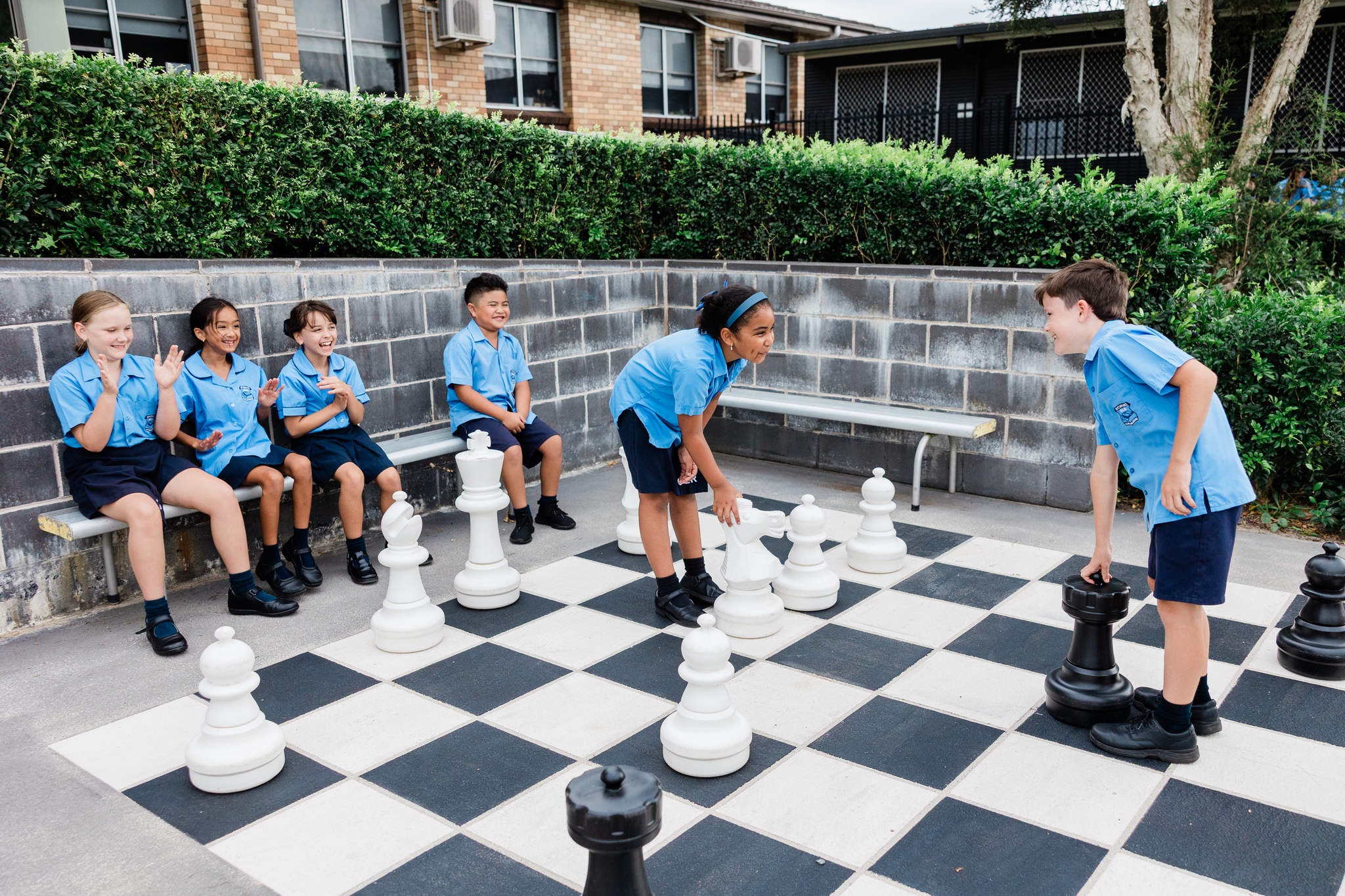 Primary school students playing outdoor chess and building confidence through play